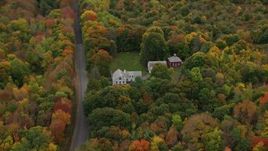 5.5K aerial stock footage flying by an isolated home, colorful forest, autumn, Manchester, Maine Aerial Stock Footage | AX150_004