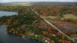 5.5K aerial stock footage flying by colorful foliage, waterfront homes, Western Avenue, autumn, Winthrop, Maine Aerial Stock Footage | AX150_007