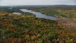 5.5K aerial stock footage flying over colorful forest, approach Upper Narrows Pond, autumn, Winthrop, Maine Aerial Stock Footage | AX150_010