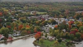 5.5K aerial stock footage flying by small town near the water, homes, factory, autumn, Winthrop, Maine Aerial Stock Footage | AX150_019