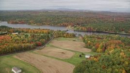 5.5K aerial stock footage flying over farm, approach Center Bridge, Androscoggin River, autumn, Leeds, Maine Aerial Stock Footage | AX150_036E