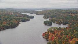 5.5K aerial stock footage flying by Androscoggin River, colorful forest in autumn, overcast, Leeds, Maine Aerial Stock Footage | AX150_038