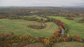 5.5K aerial stock footage flying by Nezinscot River, colorful trees, green fields, autumn, Turner, Maine Aerial Stock Footage | AX150_041