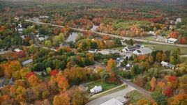 5.5K aerial stock footage flying by a small rural town, colorful foliage in autumn, Turner, Maine Aerial Stock Footage | AX150_042E