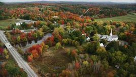 5.5K aerial stock footage orbiting a small town, church, colorful foliage in autumn, Turner, Maine Aerial Stock Footage | AX150_046