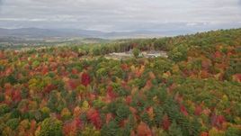 5.5K aerial stock footage flying over colorful forest, approaching an isolated home, Turner, Maine Aerial Stock Footage | AX150_054E