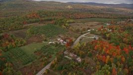 5.5K aerial stock footage flying over colorful forest, approaching Hill Road, autumn, Buckfield, Maine Aerial Stock Footage | AX150_058