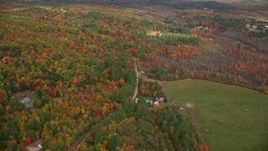 5.5K aerial stock footage flying over forest, approach rural homes near South Pond, autumn, Buckfield, Maine Aerial Stock Footage | AX150_059E