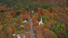 5.5K aerial stock footage flying by Union Church, small town, colorful trees in autumn, Buckfield, Maine Aerial Stock Footage | AX150_063E