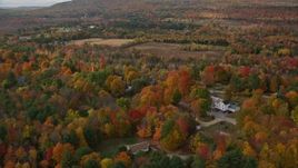 5.5K aerial stock footage orbiting small town, rural homes, brightly colored foliage, autumn, Buckfield, Maine Aerial Stock Footage | AX150_065E
