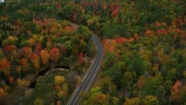 5.5K aerial stock footage flying over colorful forest, tilt down on Buckfield Road, autumn, Paris, Maine Aerial Stock Footage | AX150_079
