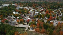 5.5K aerial stock footage flying over rural homes, approaching small town in autumn, Paris, Maine Aerial Stock Footage | AX150_091