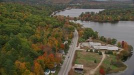 5.5K aerial stock footage flying over rural homes near Lake Road, autumn, Norway, Maine Aerial Stock Footage | AX150_098E