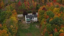 5.5K aerial stock footage flying by an isolated home, colorful trees, tilt down, autumn, Norway, Maine Aerial Stock Footage | AX150_102