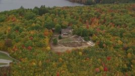 5.5K aerial stock footage approaching an isolated home, tilt down, autumn, Norway, Maine Aerial Stock Footage | AX150_103