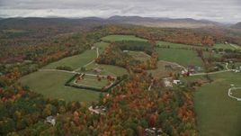 5.5K aerial stock footage approaching small farms, colorful trees in autumn, pan right, Norway, Maine Aerial Stock Footage | AX150_104E