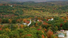 5.5K aerial stock footage orbiting colorful forest, small rural town, autumn, Waterford, Maine Aerial Stock Footage | AX150_120