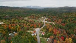 5.5K aerial stock footage flying by small rural town, Valley Road, autumn, overcast, Waterford, Maine Aerial Stock Footage | AX150_123