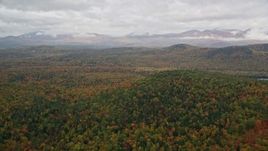 5.5K aerial stock footage flying over Peaked Hill, colorful forest, approach White Mountains, autumn, Lovell, Maine Aerial Stock Footage | AX150_141E