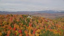 5.5K aerial stock footage flying by an isolated home, colorful forest on White Mountains, New Hampshire Aerial Stock Footage | AX150_165E