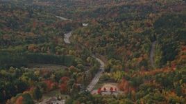 5.5K aerial stock footage flying by Route 16, brightly colored forest in autumn, Jackson, New Hampshire Aerial Stock Footage | AX150_182