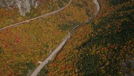 5.5K aerial stock footage of a bird's eye view over forest, Highway 302, overcast, autumn, White Mountains, New Hampshire Aerial Stock Footage | AX150_198E