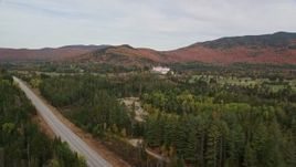 5.5K aerial stock footage tilt from highway to reveal Omni Mount Washington Resort, Bretton Woods, autumn, Carroll, New Hampshire Aerial Stock Footage | AX150_202E