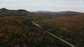 5.5K aerial stock footage approaching, flying over Highway 302, forest, autumn, overcast, Carroll, New Hampshire Aerial Stock Footage | AX150_214