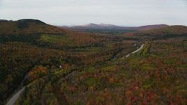 5.5K aerial stock footage flying over Highway 302, tilt down on forest, autumn, Carroll, New Hampshire Aerial Stock Footage | AX150_215