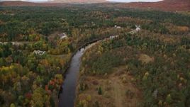 5.5K aerial stock footage flying over small rural town, Ammonoosuc River, autumn, Carroll, New Hampshire Aerial Stock Footage | AX150_220E
