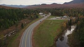5.5K aerial stock footage flying by Highway 302, North Hampshire Department of Safety, autumn, Carroll, New Hampshire Aerial Stock Footage | AX150_222E