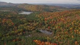 5.5K aerial stock footage flying over colorful forest, approaching Pearl Lake, autumn, Lisbon, New Hampshire Aerial Stock Footage | AX150_259E