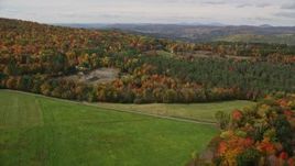 5.5K aerial stock footage fly over forest and clearings to reveal an isolated rural home, tilt down, autumn, Lisbon, New Hampshire Aerial Stock Footage | AX150_261E