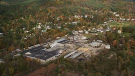 5.5K aerial stock footage flying by a factory near river, small town, autumn, Lisbon, New Hampshire Aerial Stock Footage | AX150_265
