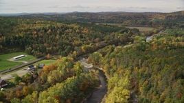 5.5K aerial stock footage flying over rural homes, Ammonoosuc River, autumn, Lisbon, New Hampshire Aerial Stock Footage | AX150_266E