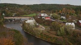 5.5K aerial stock footage approaching bridge, tilt down over church, Ammonoosuc River, autumn, Bath, New Hampshire Aerial Stock Footage | AX150_278E