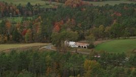 5.5K aerial stock footage flying by an isolated home and colorful foliage in autumn, Bath, New Hampshire Aerial Stock Footage | AX150_281