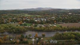5.5K aerial stock footage flying by small rural town, Connecticut River, autumn, overcast, Woodsville, New Hampshire Aerial Stock Footage | AX150_290