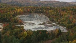 5.5K aerial stock footage approaching a small quarry, colorful trees in autumn, tilt down, Wells River, Vermont Aerial Stock Footage | AX150_307