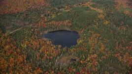 5.5K aerial stock footage approaching pond, colorful forest and tilt down, autumn, Topsham, Vermont Aerial Stock Footage | AX150_318E