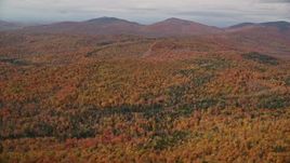 5.5K aerial stock footage flying over colorful forest, approaching distant peaks, autumn, Topsham, Vermont Aerial Stock Footage | AX150_320E