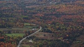 5.5K aerial stock footage flying by rural homes, Highway 302 through forest, autumn, overcast, Topsham, Vermont Aerial Stock Footage | AX150_324