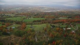 5.5K aerial stock footage flying over rural homes, colorful foliage, autumn, overcast, Barre, Vermont Aerial Stock Footage | AX150_340E