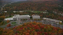 5.5K aerial stock footage approaching office buildings, parking lots and tilt down autumn, Montpelier, Vermont Aerial Stock Footage | AX150_364