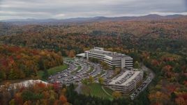 5.5K aerial stock footage orbiting brightly colored trees, large office buildings, autumn, Montpelier, Vermont Aerial Stock Footage | AX150_368E