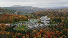 5.5K aerial stock footage orbiting office buildings, dense, colorful trees in autumn, Montpelier, Vermont Aerial Stock Footage | AX150_369