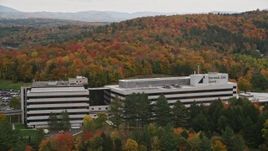 5.5K aerial stock footage orbiting office buildings surrounded by brightly colored trees, autumn, Montpelier, Vermont Aerial Stock Footage | AX150_371