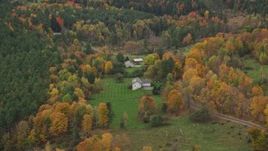 5.5K aerial stock footage flying over rural homes, colorful trees, tilt down, autumn, Montpelier, Vermont Aerial Stock Footage | AX150_394