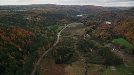 5.5K aerial stock footage following Main Street through the small town of Williamstown, Vermont in autumn Aerial Stock Footage | AX150_402E