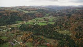 5.5K aerial stock footage flying over Route 14, Randolph Center Road and farms in autumn, Bethel, Vermont Aerial Stock Footage | AX150_415E